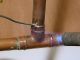 Copper pipe repair being carried out in a domestic setting
