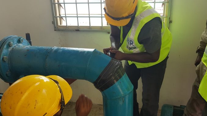 Waterproof pipe repair tape being applied to seal a leaking pipe