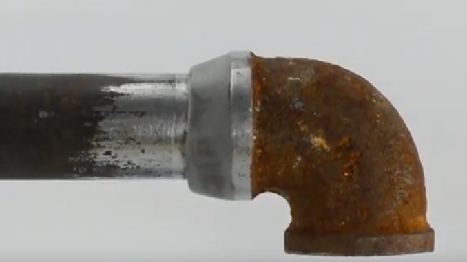 A leaking pipe joint undergoes a quick repair and fix using an epoxy putty