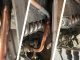 A copper pipe in a boiler system undergoes repair using Superfast Copper Epoxy Putty stick and a SylWrap HD Pipe Repair Bandage